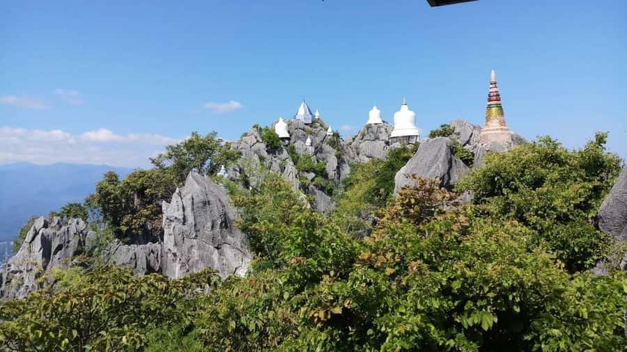 From Chiang Mai: Lampang Summit & Springs - Wat Chaloem Phrakiat, floating pagodas above the climb