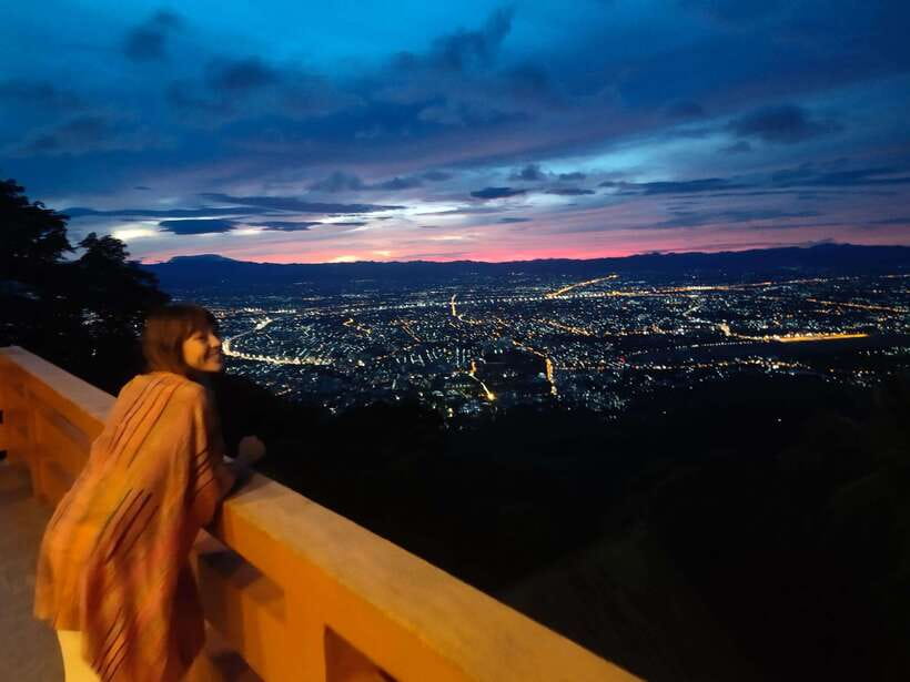 A monk watching first light over Chiang Mai from the Doi Suthep road